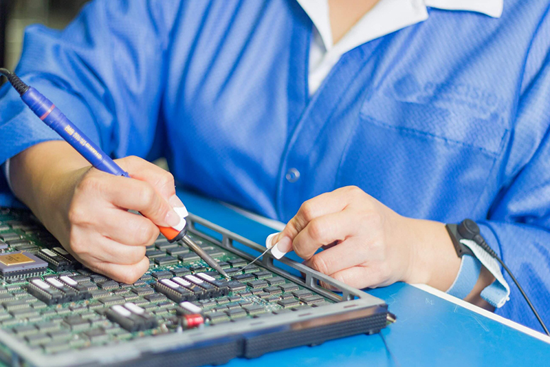 Precision ERS team member repairs electronic component